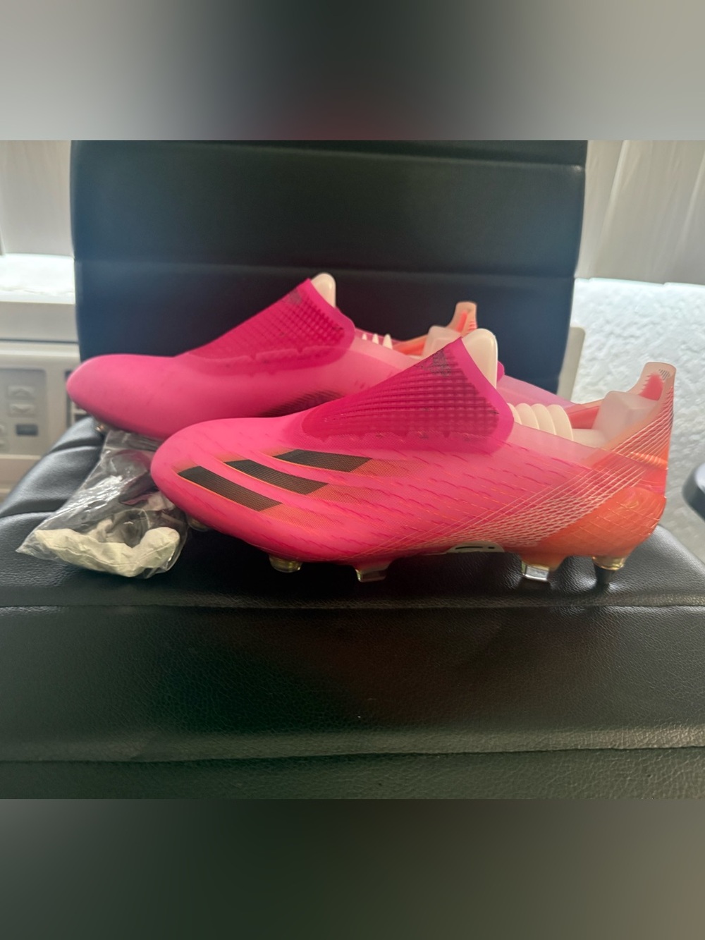adidas Laceless Soccer Cleats in Vibrant Pink with Black Stripes